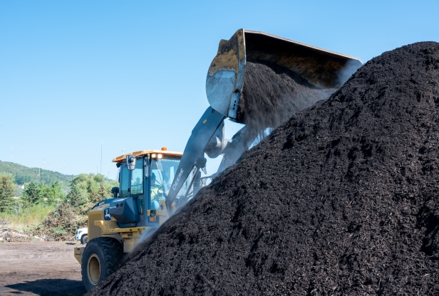 Turning compost at Resource Renew, a yard waste and food scraps composting site.