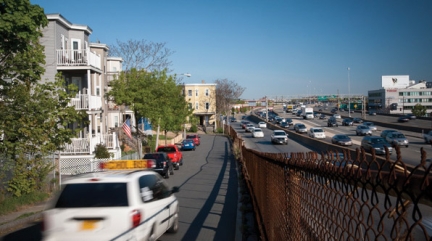 Busy multi-lane freeway in front of homes