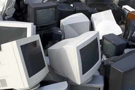 Old cathode ray tube (CRT) computer monitors and televisions waiting to be recycled.