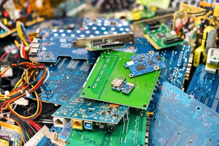 Electronic waste from discarded circuit boards and laptop parts.
