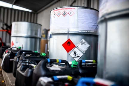 Metal barrels with hazardous waste labels.