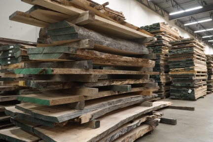 Stacks of lumber in a warehouse.