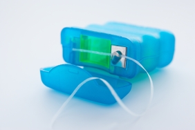 unbranded dental floss in a blue container