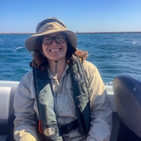 Allison Gamble in a boat on a lake.