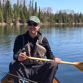 Jesse Anderson in a canoe on a lake.