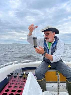 Mark Edlund collects samples of sediment from Lake of the Woods