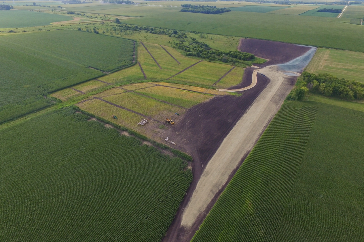 Aerial view of a storm berm and farm fields with bare soil where there was flooding.