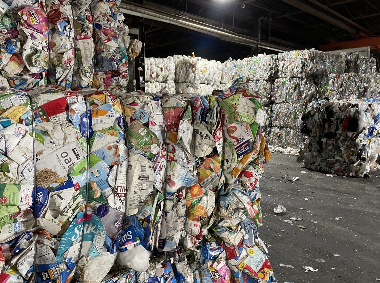 baled paper and plastic cartons sorted and ready to be recycled