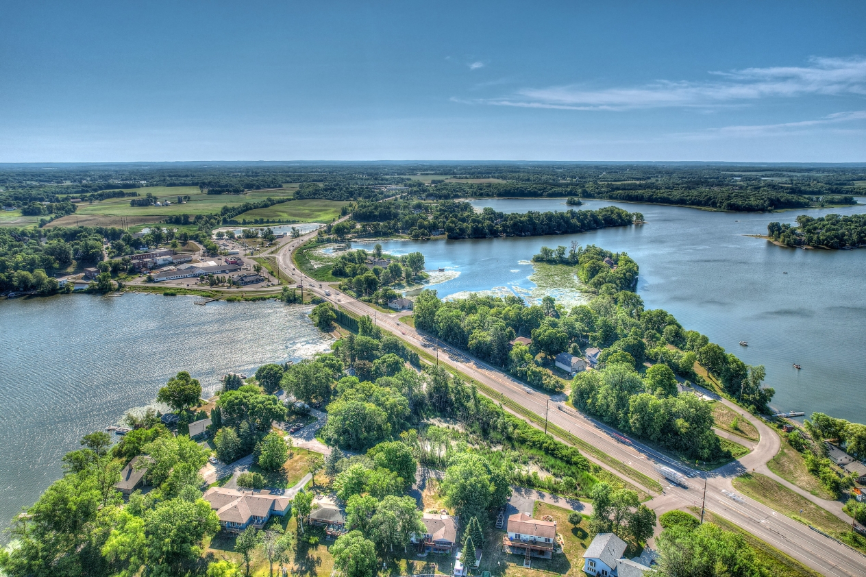 Aerial view of a highway bridging two connecting lakes.