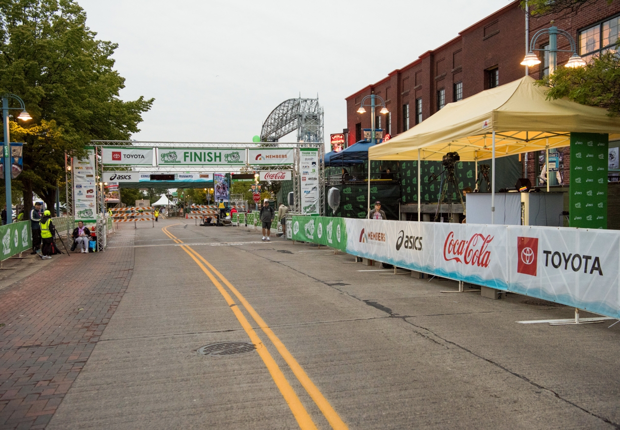The finish line for a race on a Duluth city street with the lift bridge in the background.