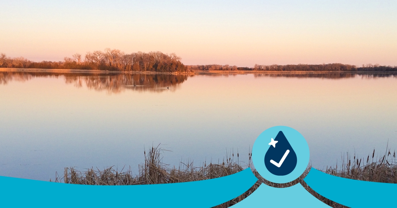 A very calm, still lake at sunset in autumn.
