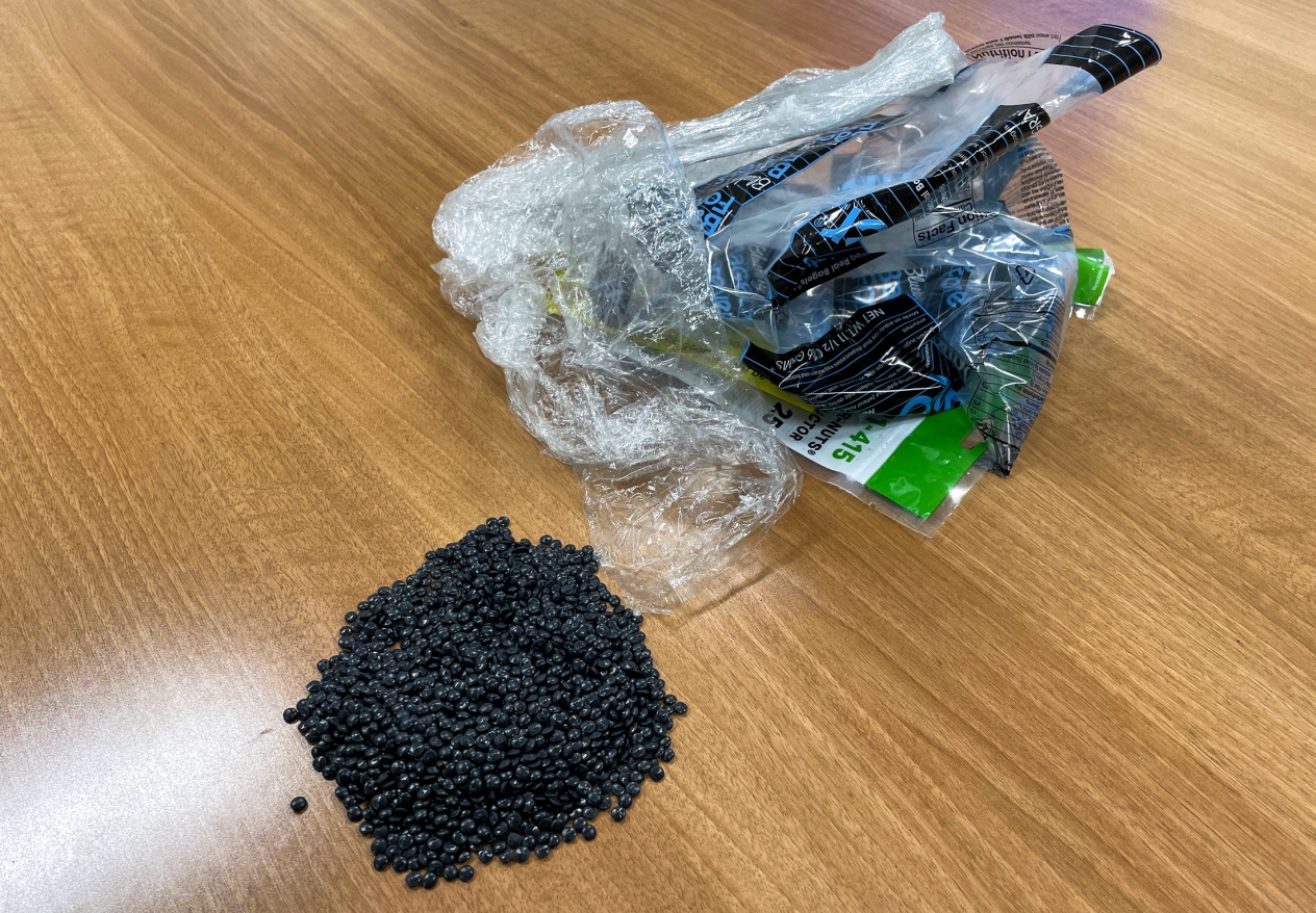 a pile of black plastic nurdles with polyethylene plastic waste typically used for feedstock to make the nurdles