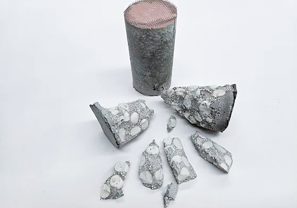 Concrete cylinder and broken pieces of concrete.