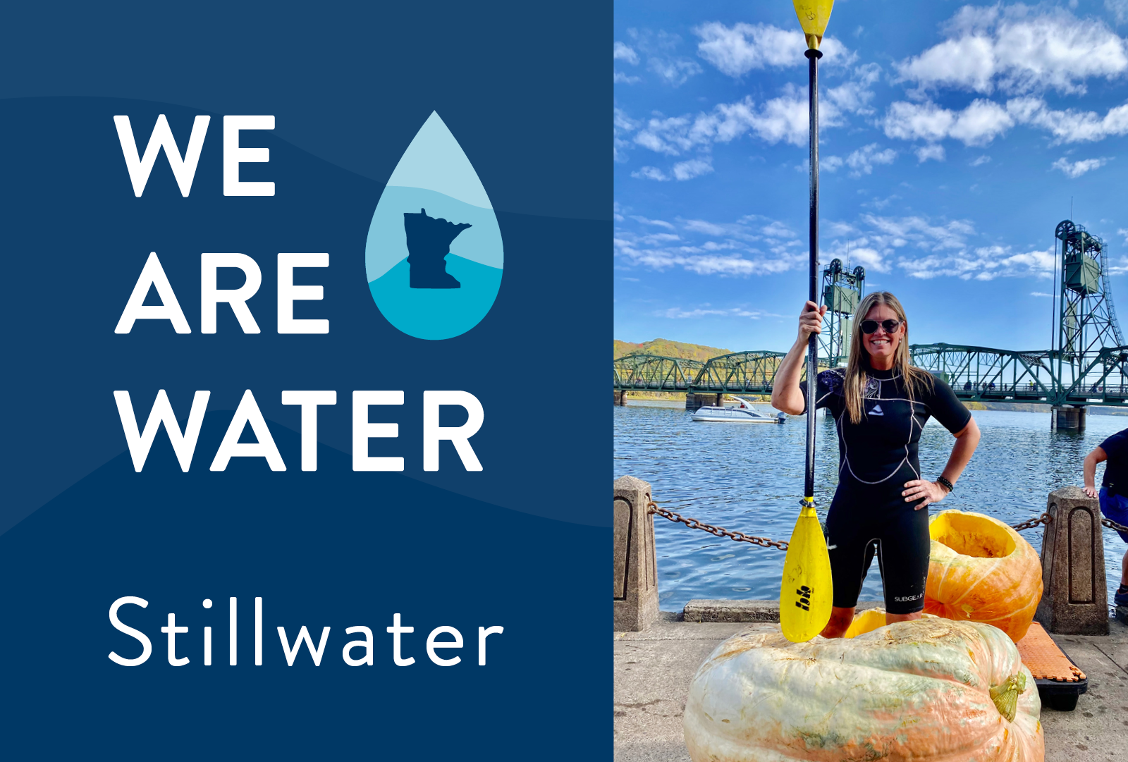 We Are Water Stillwater logo and image of woman standing in a giant pumpkin in front of a river holding a kayak paddle.
